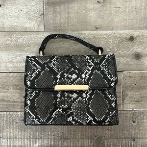 I’m selling a black and white snake skin purse it is from TJmaxx